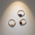 All three pearl rings white background
